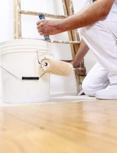 painter man at work with a roller, bucket and scale, bottom view