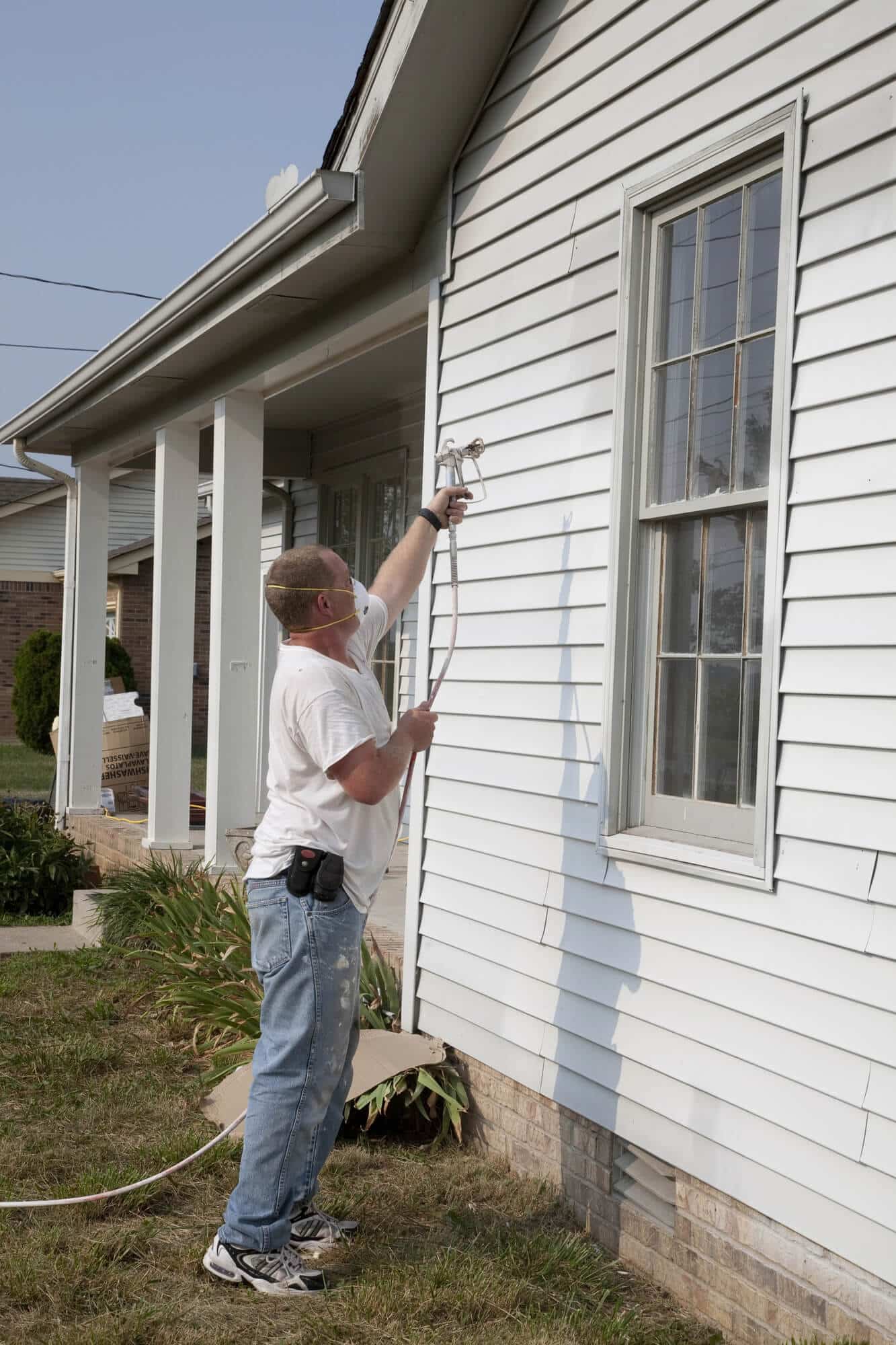 contractor painting the exterior of a house