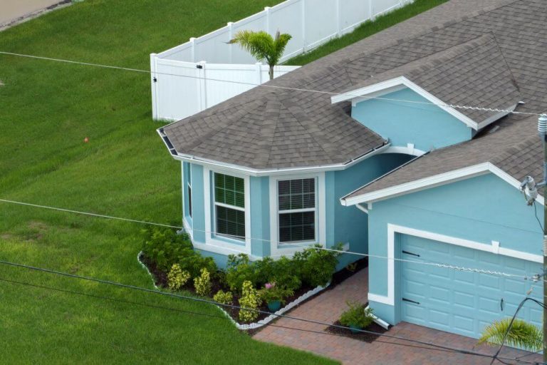 Light blue house in a suburb - TurnKey Painter